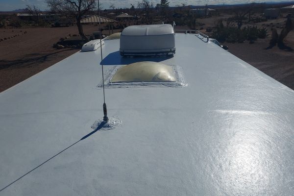 RV roof coated with liquid rubber roof coating showing a smooth, waterproof finish and sealed vents for long-lasting rubber roof repair.